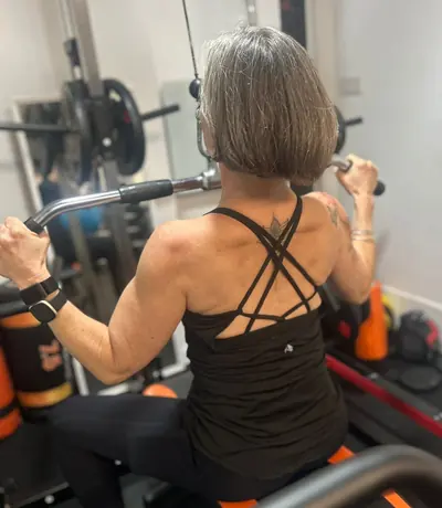 Liz Shaw strength training on the lat pulldown at The Everstrong Gym, Ealing